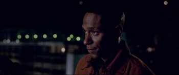 Movie still from “The Italian Job” (2003), directed by F. Gary Gray – A person wearing a brown jacket; Close Up shot, Over the shoulder angle