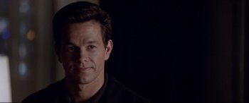 Movie still from “The Italian Job” (2003), directed by F. Gary Gray – A person wearing a black shirt; Close Up shot, Over the shoulder angle