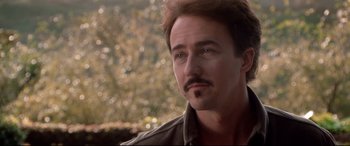 Movie still from “The Italian Job” (2003), directed by F. Gary Gray – A person with a mustache; Close Up shot, Over the shoulder angle