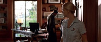 Movie still from “The Italian Job” (2003), directed by F. Gary Gray – A woman standing in front of a computer in a room; Medium shot, Over the shoulder angle