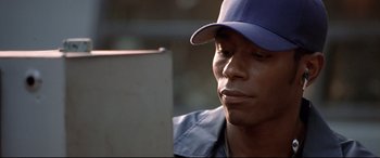 Movie still from “The Italian Job” (2003), directed by F. Gary Gray – A person wearing a hat; Close Up shot, Low angle
