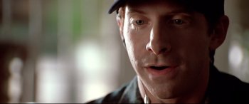 Movie still from “The Italian Job” (2003), directed by F. Gary Gray – A person wearing a hat and looking at the camera; Extreme Close Up shot, Low angle