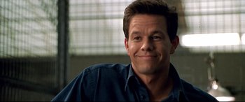 Movie still from “The Italian Job” (2003), directed by F. Gary Gray – A person wearing a blue shirt; Close Up shot, Over the shoulder angle