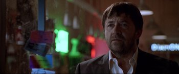 Movie still from “The Italian Job” (2003), directed by F. Gary Gray – A person wearing a suit and tie; Close Up shot, Low angle