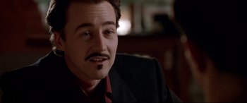 Movie still from “The Italian Job” (2003), directed by F. Gary Gray – A person wearing a suit and tie; Close Up shot, Low angle