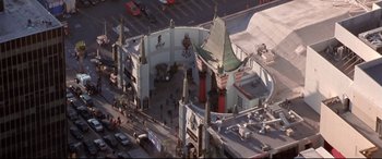 Movie still from “The Italian Job” (2003), directed by F. Gary Gray – An aerial view of a movie theater in the middle of a street; Extreme Wide shot, High angle