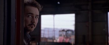 Movie still from “The Italian Job” (2003), directed by F. Gary Gray – A man's face in front of a window; Close Up shot, Over the shoulder angle