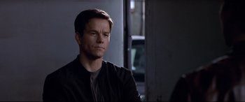 Movie still from “The Italian Job” (2003), directed by F. Gary Gray – A person wearing a black jacket; Close Up shot, Over the shoulder angle