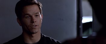 Movie still from “The Italian Job” (2003), directed by F. Gary Gray – A person wearing a black t - shirt; Close Up shot, Over the shoulder angle