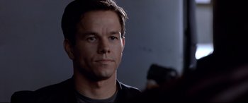 Movie still from “The Italian Job” (2003), directed by F. Gary Gray – A person taking a picture with a camera; Close Up shot, Over the shoulder angle