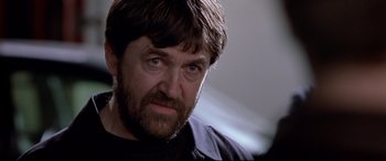 Movie still from “The Italian Job” (2003), directed by F. Gary Gray – A person wearing a black shirt; Close Up shot, Over the shoulder angle