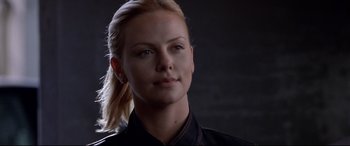 Movie still from “The Italian Job” (2003), directed by F. Gary Gray – A person wearing a black shirt; Close Up shot, Over the shoulder angle