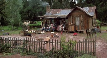 Movie still from “The Jerk” (1979), directed by Carl Reiner – A group of people sitting in front of a house; Extreme Wide shot, High angle