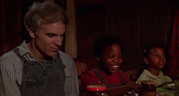 Movie still from “The Jerk” (1979), directed by Carl Reiner – A man sitting next to a young boy at a dinner table; Close Up shot, Low angle