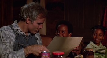 Movie still from “The Jerk” (1979), directed by Carl Reiner – A man sitting at a dinner table with a child; Close Up shot, Over the shoulder angle