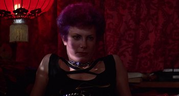 Movie still from “The Jerk” (1979), directed by Carl Reiner – A woman with purple hair is sitting in a room; Close Up shot, Low angle