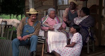 Movie still from “The Jerk” (1979), directed by Carl Reiner – A group of people sitting on a porch reading; Wide shot, High angle
