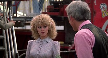 Movie still from “The Jerk” (1979), directed by Carl Reiner – A woman in a pink shirt is talking to an older man; Close Up shot, Over the shoulder angle