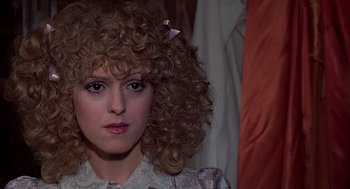 Movie still from “The Jerk” (1979), directed by Carl Reiner – A person with curly blonde hair; Close Up shot, Over the shoulder angle
