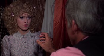 Movie still from “The Jerk” (1979), directed by Carl Reiner – A woman with curly blonde hair looking in a mirror; Close Up shot, Over the shoulder angle
