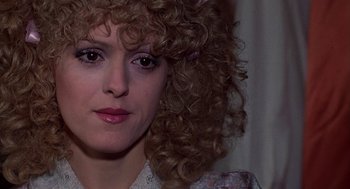Movie still from “The Jerk” (1979), directed by Carl Reiner – A person with curly brown hair; Close Up shot, Over the shoulder angle