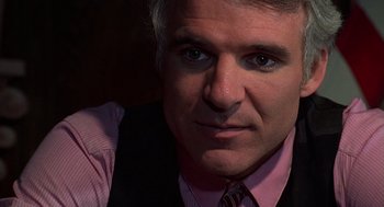 Movie still from “The Jerk” (1979), directed by Carl Reiner – A person wearing a suit and tie; Close Up shot, Over the shoulder angle