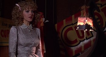Movie still from “The Jerk” (1979), directed by Carl Reiner – A woman with blonde curly hair standing next to a fire hydrant; Medium shot, Over the shoulder angle