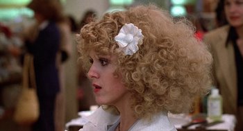 Movie still from “The Jerk” (1979), directed by Carl Reiner – A person with a flower in her hair; Close Up shot, Over the shoulder angle