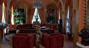 Movie still from “The Jerk” (1979), directed by Carl Reiner – A living room filled with furniture and a chandelier in it; Extreme Wide shot, High angle