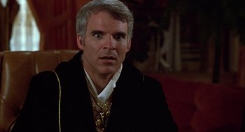 Movie still from “The Jerk” (1979), directed by Carl Reiner – A person wearing a suit and tie; Close Up shot, Over the shoulder angle