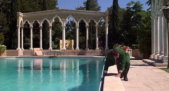 Movie still from “The Jerk” (1979), directed by Carl Reiner – A man leaning over the edge of a swimming pool; Wide shot, High angle