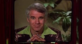 Movie still from “The Jerk” (1979), directed by Carl Reiner – A person sitting at a table; Close Up shot, Over the shoulder angle