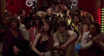 Movie still from “The Jerk” (1979), directed by Carl Reiner – A group of people sitting on the floor of a room; Wide shot, High angle