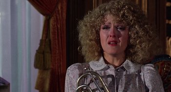 Movie still from “The Jerk” (1979), directed by Carl Reiner – A woman crying while holding onto a trumpet; Close Up shot, Over the shoulder angle