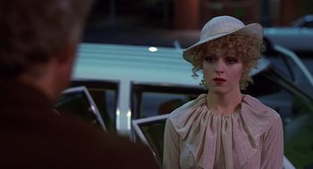 Movie still from “The Jerk” (1979), directed by Carl Reiner – A woman in a hat sitting in front of a car; Close Up shot, Over the shoulder angle