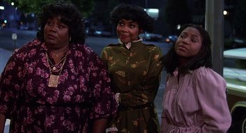 Movie still from “The Jerk” (1979), directed by Carl Reiner – A group of women standing next to each other on a street; Medium shot, Low angle