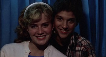 Movie still from “The Karate Kid” (1984), directed by John G. Avildsen – Two young people posing for a picture together; Close Up shot, Overhead angle