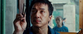 Movie still from “The Karate Kid” (2010), directed by Harald Zwart – A person holding a cell phone up to their head; Close Up shot, Low angle