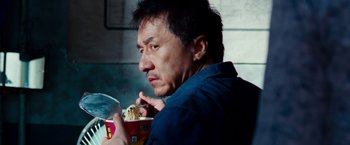 Movie still from “The Karate Kid” (2010), directed by Harald Zwart – A man eating a bowl of noodles while holding a spoon; Close Up shot, Low angle