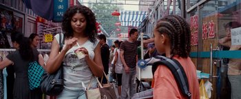 Movie still from “The Karate Kid” (2010), directed by Harald Zwart – A group of people walking down a street; Medium shot, Over the shoulder angle
