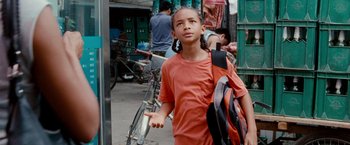 Movie still from “The Karate Kid” (2010), directed by Harald Zwart – A young boy is walking down the street with a backpack; Close Up shot, Low angle