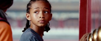 Movie still from “The Karate Kid” (2010), directed by Harald Zwart – A person wearing a gray shirt; Close Up shot, Low angle