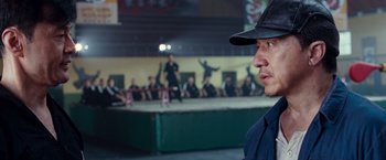 Movie still from “The Karate Kid” (2010), directed by Harald Zwart – A man wearing a black hat and a blue shirt; Close Up shot, Over the shoulder angle