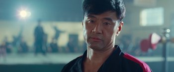 Movie still from “The Karate Kid” (2010), directed by Harald Zwart – A person wearing a black shirt; Close Up shot, Low angle