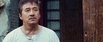 Movie still from “The Karate Kid” (2010), directed by Harald Zwart – A person wearing a white t - shirt; Close Up shot, Low angle