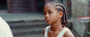 Movie still from “The Karate Kid” (2010), directed by Harald Zwart – A young girl with braids is looking at the camera; Close Up shot, Low angle