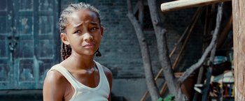 Movie still from “The Karate Kid” (2010), directed by Harald Zwart – A young girl in a white tank top looking at the camera; Close Up shot, Low angle