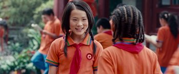 Movie still from “The Karate Kid” (2010), directed by Harald Zwart – A young girl wearing a red shirt and a red tie; Close Up shot, Over the shoulder angle
