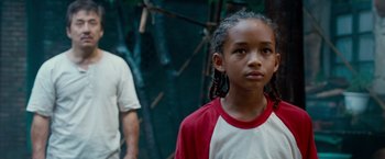 Movie still from “The Karate Kid” (2010), directed by Harald Zwart – A young girl standing in front of a man; Close Up shot, Over the shoulder angle