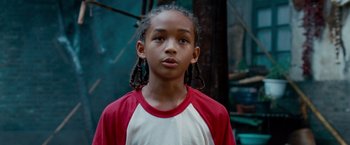 Movie still from “The Karate Kid” (2010), directed by Harald Zwart – A young boy wearing a red and white t - shirt; Close Up shot, Low angle